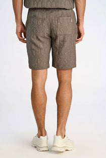Back image of a model wearing the Textured shorts in khaki, by brand Lindbergh