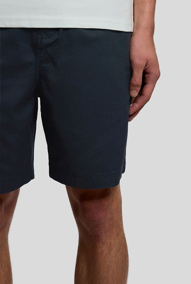 Front image of a model wearing Everyday shorts in navy, by brand Lyle and scott