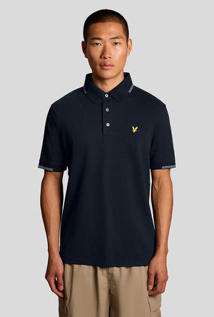 Front image of a model wearing the Fine tipped polo in navy, by brand Lyle and scott