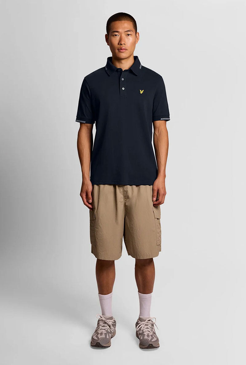 Front image of a model wearing Fine tipped polo in navy, by brand Lyle and scott