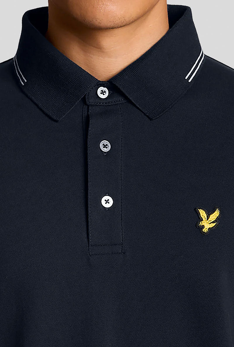 Front neck and button detail image of a model wearing Fine tipped polo in navy, by brand Lyle and scott