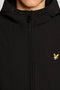 Front image of a model wearing the Fleece back softshell jacket in black, by brand Lyle and scott
