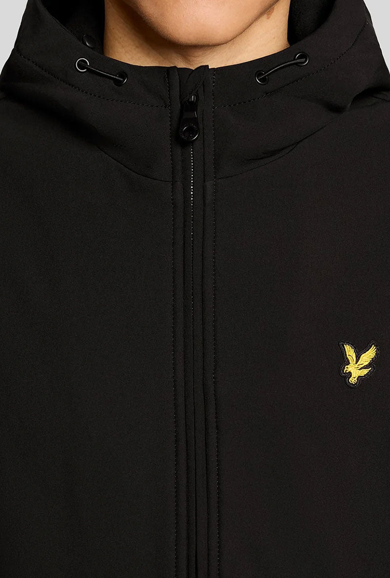 Front image of a model wearing Fleece back softshell jacket in black, by brand Lyle and scott