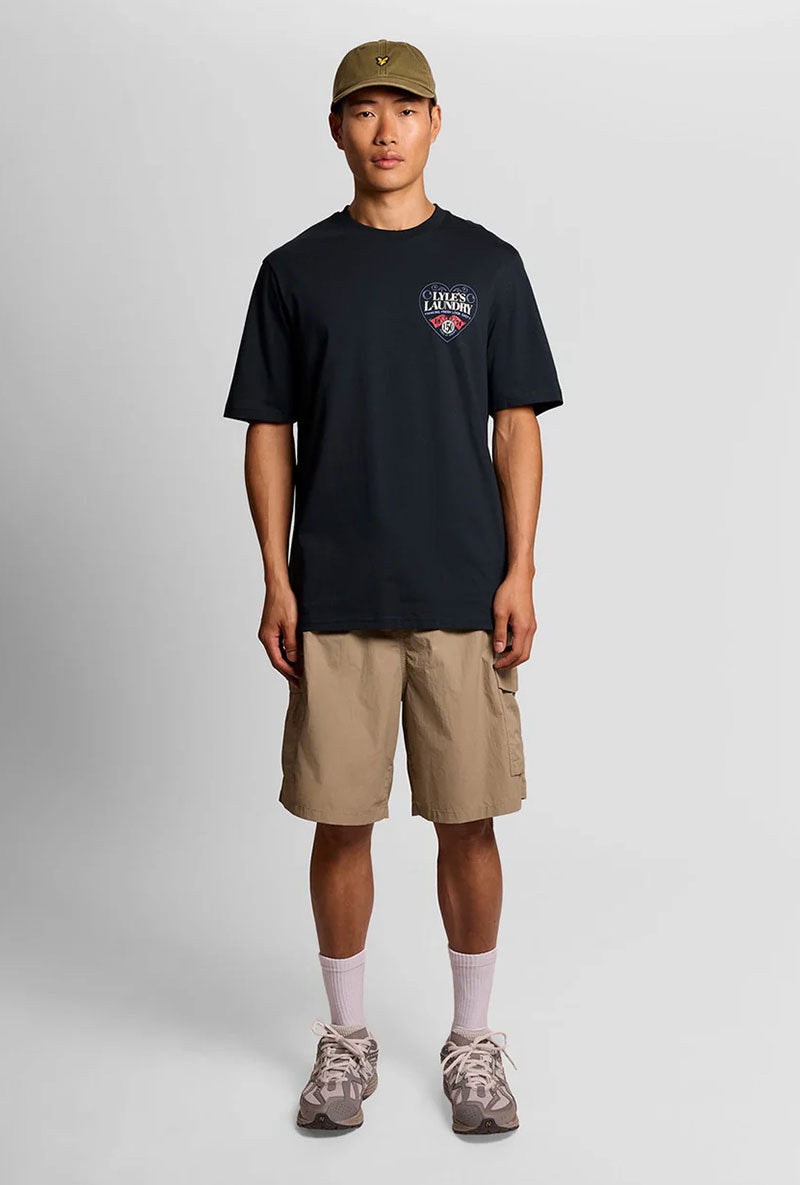 Front image of a model wearing Lyles laundry graphic t in navy, by brand Lyle and scott