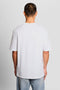 Back image of a model wearing the Lyles laundry graphic t in white, by brand Lyle and scott