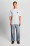 Front image of a model wearing the Lyles laundry graphic t in white, by brand Lyle and scott
