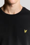 Front neck detail image of a model wearing the Plain logo tshirt in black, by brand Lyle and scott