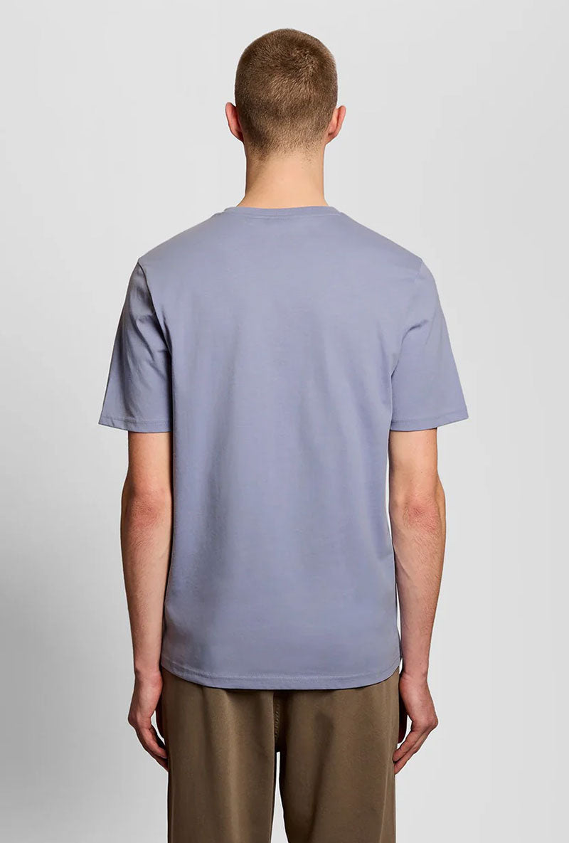 Back image of a model wearing Plain logo tshirt in blue, by brand Lyle and scott