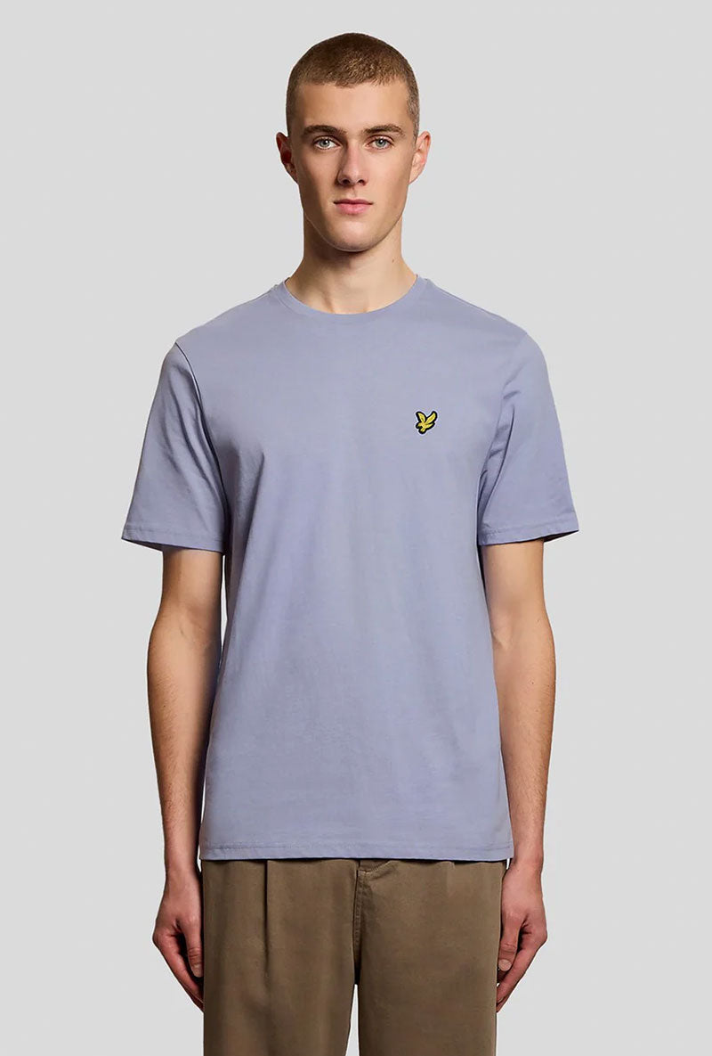 Front image of a model wearing Plain logo tshirt in blue, by brand Lyle and scott