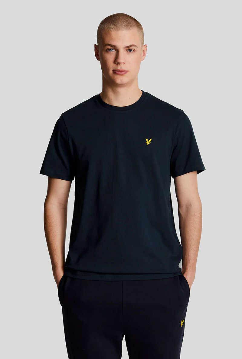 Front image of a model wearing Plain logo tshirt in navy, by brand Lyle and scott