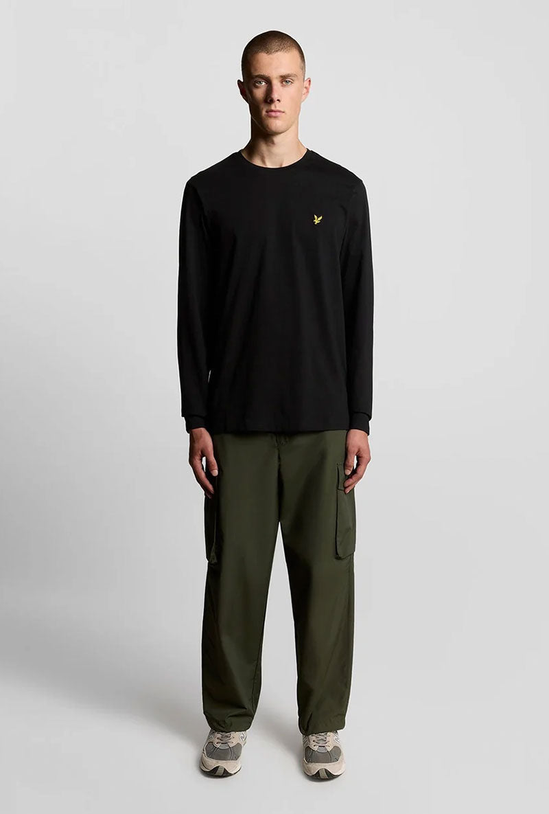 Front image of a model wearing Plain ls tshirt in black, by brand Lyle and scott