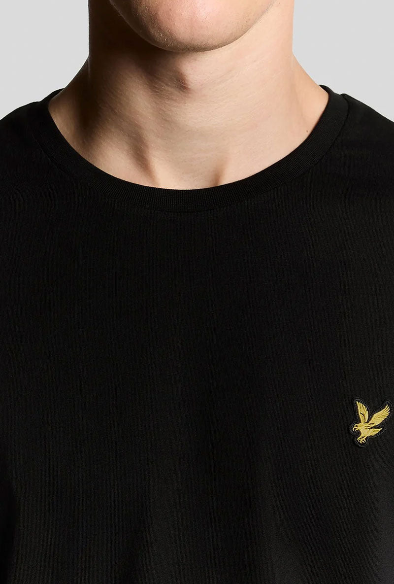 Front image of a model wearing Plain ls tshirt in black, by brand Lyle and scott