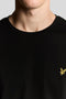 Front image of a model wearing the Plain ls tshirt in black, by brand Lyle and scott