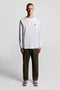 Front image of a model wearing the Plain ls tshirt in white, by brand Lyle and scott