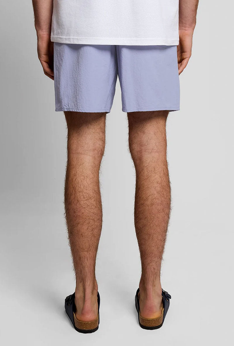 Back image of a model wearing Plain swimshorts in blue, by brand Lyle and scott