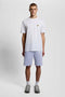 Front image of a model wearing the Sweat shorts in blue, by brand Lyle and scott