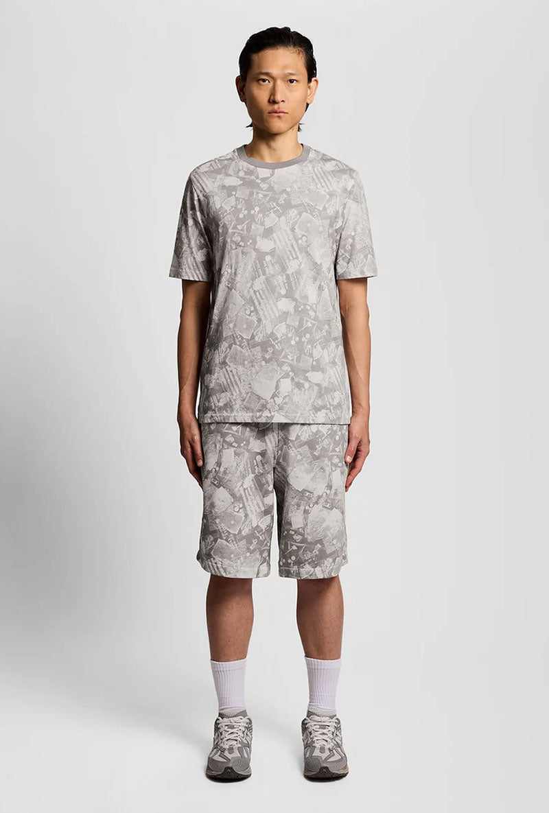 Front image of a model wearing Industrial print sweat shorts in grey, by brand Lyle and scott