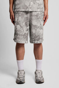 Front image of a model wearing the Industrial print sweat shorts in grey, by brand Lyle and scott