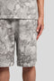 Front detail image of a model wearing the Industrial print sweat shorts in grey, by brand Lyle and scott