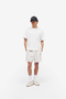 Front image of a model wearing wearing Micro owners club mesh shorts in cream, by brand Represent