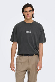 Front image of a model wearing the Fred creative washed tee in black, by brand Only and sons