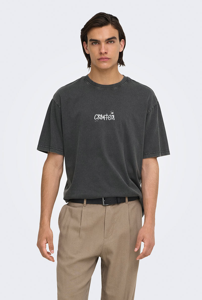 Front image of a model wearing Fred creative washed tee in black, by brand Only and sons