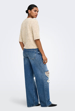 Back image of a model wearing the Bouble ss vneck button cardigan in stone, by brand Only