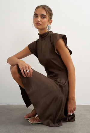 Front image of a model wearing the Cilly sation flippy hem mini dress in chocolate, by brand Top shop