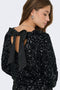 Back image of a model wearing the Confidence ls sequin bow top in black, by brand Only