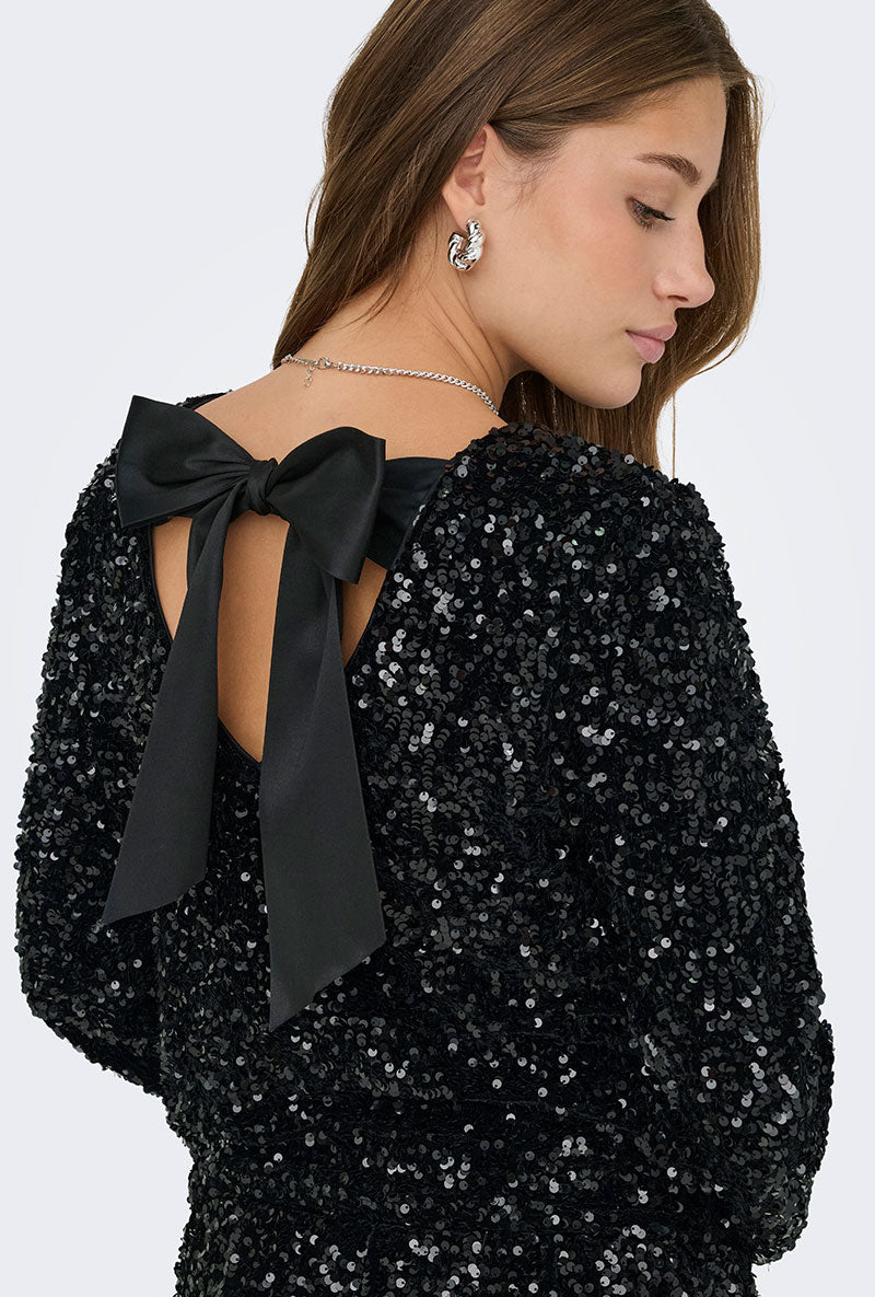 Back image of a model wearing Confidence ls sequin bow top in black, by brand Only