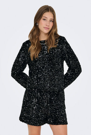 Front image of a model wearing the Confidence ls sequin bow top in black, by brand Only