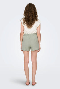 Back image of a model wearing the Theis life mw shorts in sage, by brand Jacqueline de yong
