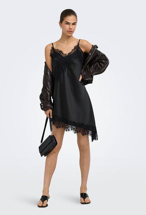 Front image of a model wearing Lindona strap satin lace dress in black, by brand Only