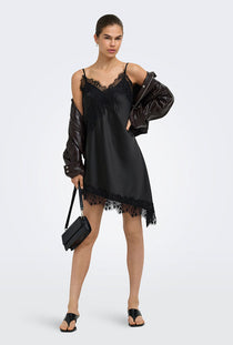 Front image of a model wearing the Lindona strap satin lace dress in black, by brand Only