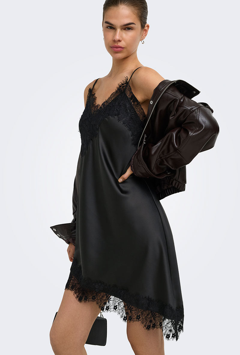 Front image of a model wearing Lindona strap satin lace dress in black, by brand Only