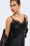 Front image of a model wearing the Lindona strap satin lace dress in black, by brand Only