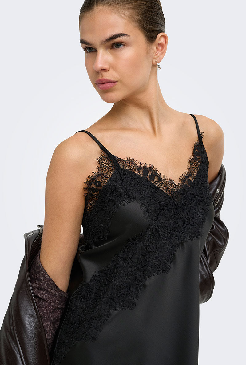 Front image of a model wearing Lindona strap satin lace dress in black, by brand Only