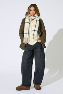 Front image of a model wearing the Mathilde check fringe scarf in grey, by brand Only