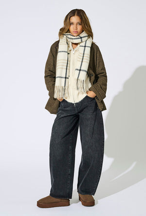 Front image of a model wearing the Mathilde check fringe scarf in grey, by brand Only