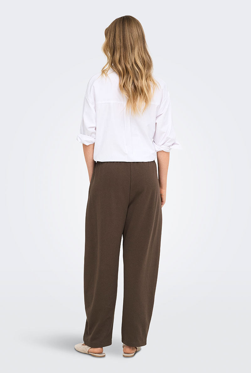 Back image of a model wearing Ofelia sweatpants in brown, by brand Only