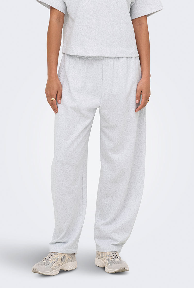 Front image of a model wearing Ofelia sweatpants in light grey, by brand Only