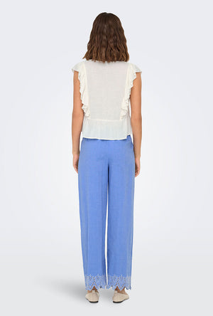 Back image of a model wearing the Only paula tulum emb trousers in blue, by brand Only