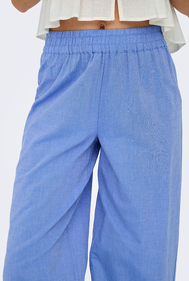 Front detail image of a model wearing Only paula tulum emb trousers in blue, by brand Only