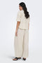 Back image of a model wearing the Tizana stripe s/s shirt in stripe, by brand Only