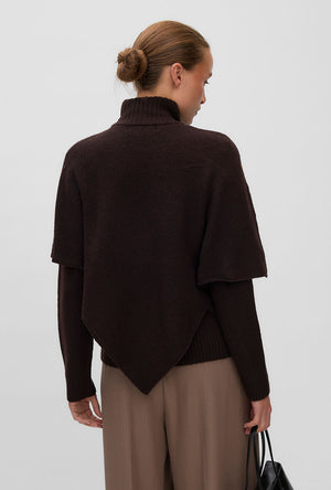 Back image of a model wearing the Camila ls cape higneck pullover in chocolate, by brand Vero moda