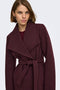 Front image of a model wearing the Trish wrap coat in chocolate, by brand Only