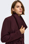 Front image of a model wearing the Trish wrap coat in chocolate, by brand Only