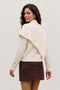 Back image of a model wearing the Camila ls cape higneck pullover in cream, by brand Vero moda