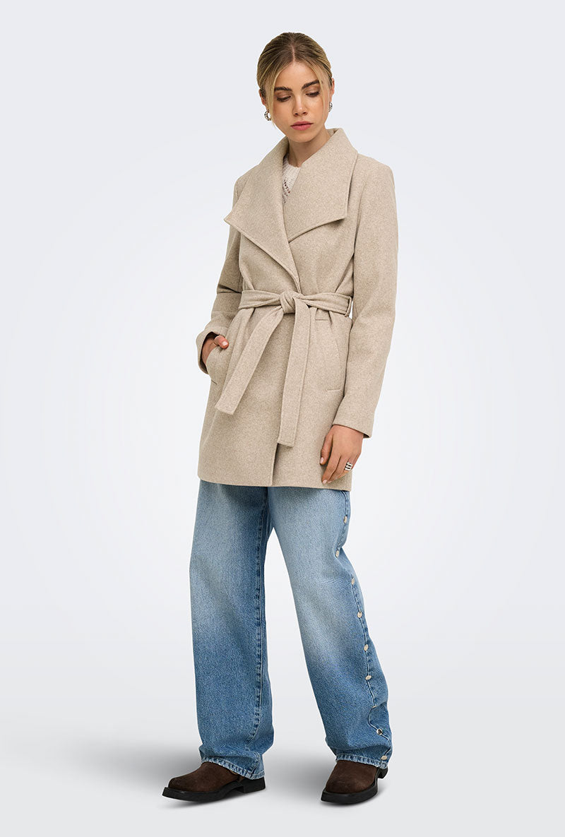 Front image of a model wearing Trish wrap coat in light brown, by brand Only