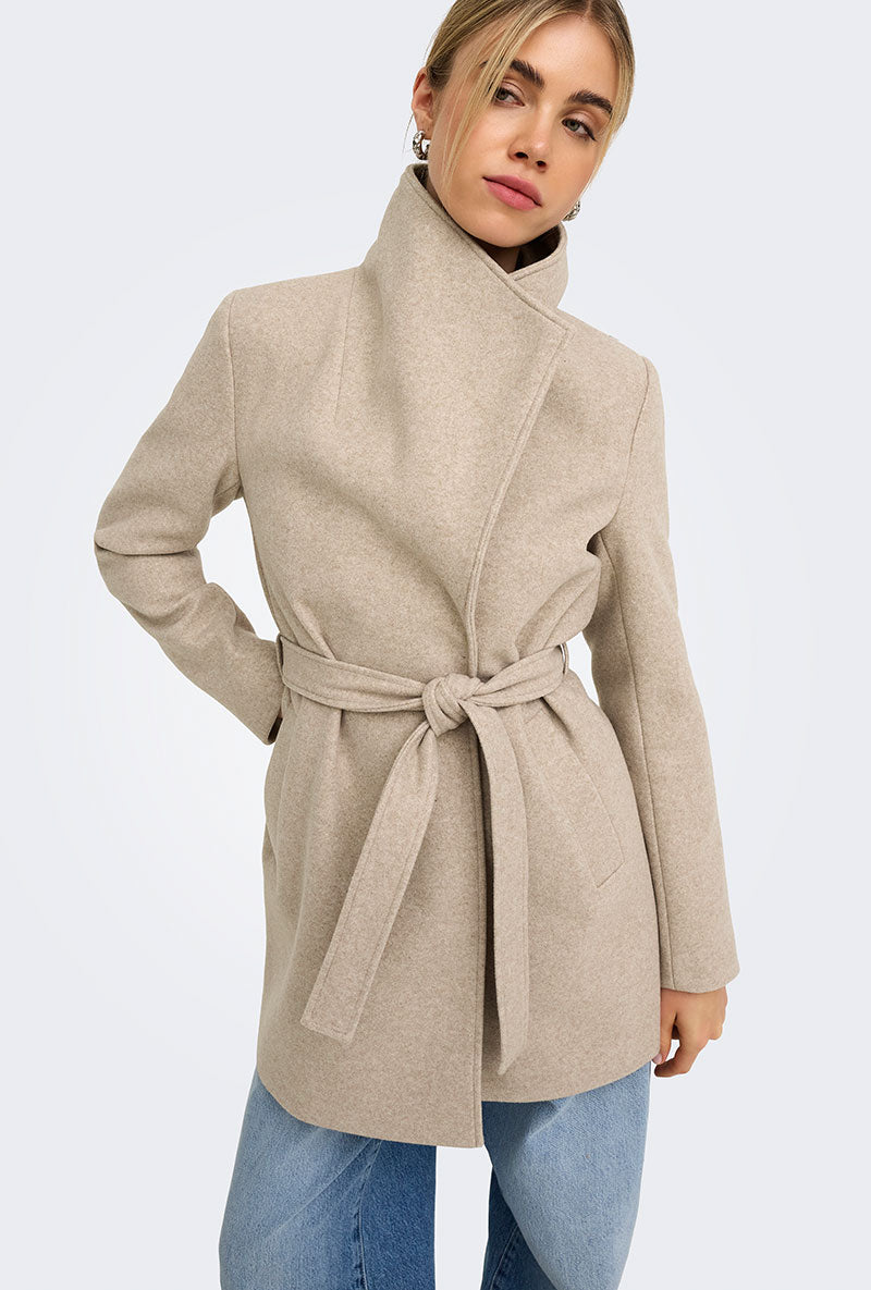 Front image of a model wearing Trish wrap coat in light brown, by brand Only
